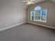 Spacious bedroom with carpeted floor and large window at 1206 Persimmon Way, Mcdonough, GA 30252