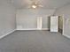 Spacious bonus room with carpeted floor and ceiling fan at 1206 Persimmon Way, Mcdonough, GA 30252