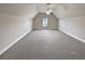 Bright bonus room featuring a window and carpet flooring at 1206 Persimmon Way, Mcdonough, GA 30252