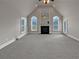 Living room with vaulted ceiling, fireplace and carpet at 1206 Persimmon Way, Mcdonough, GA 30252