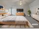 Virtually staged main bedroom with a large bed, dresser, and carpet flooring at 1206 Persimmon Way, Mcdonough, GA 30252