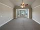 Main bedroom with bay windows, tray ceiling and ceiling fan at 1206 Persimmon Way, Mcdonough, GA 30252