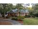 House nestled in woods with a circular driveway and manicured lawn at 992 Pj East Rd, Covington, GA 30014