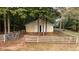 Large barn with double doors, set within a fenced area at 992 Pj East Rd, Covington, GA 30014