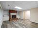 Finished basement with brick fireplace and built-in shelving at 992 Pj East Rd, Covington, GA 30014