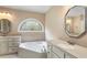 Bathroom with double vanity, soaking tub, and stained glass window at 992 Pj East Rd, Covington, GA 30014