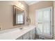 Bathroom with white vanity, mirror, and window with shutters at 992 Pj East Rd, Covington, GA 30014