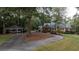 Long driveway leading to a two-story brick home with detached carport at 992 Pj East Rd, Covington, GA 30014
