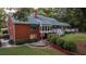 Brick house with large deck, patio, and lush landscaping at 992 Pj East Rd, Covington, GA 30014