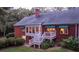 Brick house with a sunroom and deck overlooking the backyard at 992 Pj East Rd, Covington, GA 30014