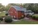 Brick house with large deck and manicured lawn at 992 Pj East Rd, Covington, GA 30014