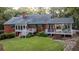 Brick house with expansive deck and surrounding greenery at 992 Pj East Rd, Covington, GA 30014