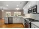 Modern kitchen with stainless steel appliances and white cabinetry at 992 Pj East Rd, Covington, GA 30014