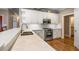 White kitchen with quartz countertops and stainless steel appliances at 992 Pj East Rd, Covington, GA 30014