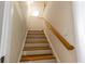 Wooden staircase with a wooden handrail leading to the upper level at 992 Pj East Rd, Covington, GA 30014