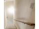 Carpeted staircase with wooden handrail leading downstairs at 992 Pj East Rd, Covington, GA 30014