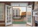 Balcony view from living room showcasing French doors, iron railing, and exterior landscape view at 340 Town Center Ave # 215, Suwanee, GA 30024