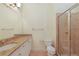 Well-appointed bathroom with granite countertop, vanity, toilet, and glass-enclosed tiled shower at 340 Town Center Ave # 215, Suwanee, GA 30024