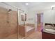 The bathroom is complete with a glass enclosed shower, soaking tub, and double sinks at 340 Town Center Ave # 215, Suwanee, GA 30024