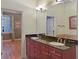 The double vanity bathroom offers granite counters and modern lighting fixtures at 340 Town Center Ave # 215, Suwanee, GA 30024