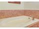 A soaking tub is surrounded by tiled accents and is perfect for relaxation at 340 Town Center Ave # 215, Suwanee, GA 30024