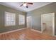 Cozy bedroom with bright windows, stylish ceiling fan, and access to en-suite bathroom at 340 Town Center Ave # 215, Suwanee, GA 30024