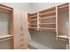 Walk-in closet with light wood shelving and drawers at 340 Town Center Ave # 215, Suwanee, GA 30024