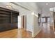 Hallway with hardwood floors, built-in bookshelves, and access to multiple rooms and staircase at 340 Town Center Ave # 215, Suwanee, GA 30024
