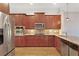 Well-equipped kitchen boasts stainless appliances, granite countertops, and rich wood cabinetry at 340 Town Center Ave # 215, Suwanee, GA 30024