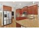 Gourmet kitchen featuring stainless steel appliances, granite countertops, and wood cabinets at 340 Town Center Ave # 215, Suwanee, GA 30024