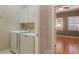 Efficient laundry room with white cabinets, washer, and dryer, ensuring seamless laundry experience at 340 Town Center Ave # 215, Suwanee, GA 30024