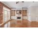 Living room featuring hardwood floors, a fireplace with built-ins, and French doors to a balcony at 340 Town Center Ave # 215, Suwanee, GA 30024