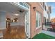 Spacious living room featuring hardwood floors, ceiling fan, and an open layout into kitchen area at 340 Town Center Ave # 215, Suwanee, GA 30024