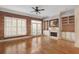 Bright living room with hardwood floors, fireplace, built-ins, and access to balcony through French doors at 340 Town Center Ave # 215, Suwanee, GA 30024