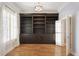 Charming office space with built-in dark wood shelves and plantation shutters offering ample storage and natural light at 340 Town Center Ave # 215, Suwanee, GA 30024