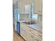 Bright kitchen with white cabinets, stainless steel appliances, and granite countertops at 553 W Sandtown Sw Rd, Marietta, GA 30064