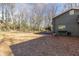 House and backyard with pine straw and trees at 285 Glen Lake Dr, Sandy Springs, GA 30327