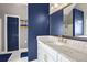 Elegant bathroom with a white vanity and blue walls at 405 Marvin Ct, Mcdonough, GA 30252