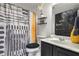 Modern bathroom with black vanity and patterned shower curtain at 405 Marvin Ct, Mcdonough, GA 30252