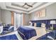 Spacious primary bedroom with plush bedding and large window at 405 Marvin Ct, Mcdonough, GA 30252