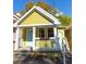 Charming yellow house with white porch and landscaping at 575 Rockwell Sw St, Atlanta, GA 30310