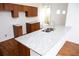 Granite countertop kitchen island with wood cabinets at 575 Rockwell Sw St, Atlanta, GA 30310