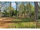 Large backyard with mature trees and fire pit at 9012 Hurst Ct, Jonesboro, GA 30238