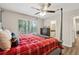 Primary bedroom with four-poster bed, en-suite bathroom access, and large window at 9012 Hurst Ct, Jonesboro, GA 30238