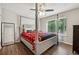 Spacious primary bedroom with large four-poster bed and window at 9012 Hurst Ct, Jonesboro, GA 30238