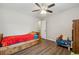 Cozy bedroom with twin bed, dresser, and wood floors at 9012 Hurst Ct, Jonesboro, GA 30238