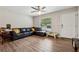 Living room with L-shaped sofa and wood-look floors, near front entrance at 9012 Hurst Ct, Jonesboro, GA 30238