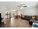 Open living area with L-shaped sectional sofa and wood-look floors at 9012 Hurst Ct, Jonesboro, GA 30238