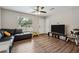Living room with L-shaped sofa and wood-look floors, near front entrance at 9012 Hurst Ct, Jonesboro, GA 30238