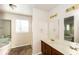 Bathroom featuring double sinks with dark wood cabinets, tile floor, and separate tub and shower at 380 Oak Landing Cir, Douglasville, GA 30134